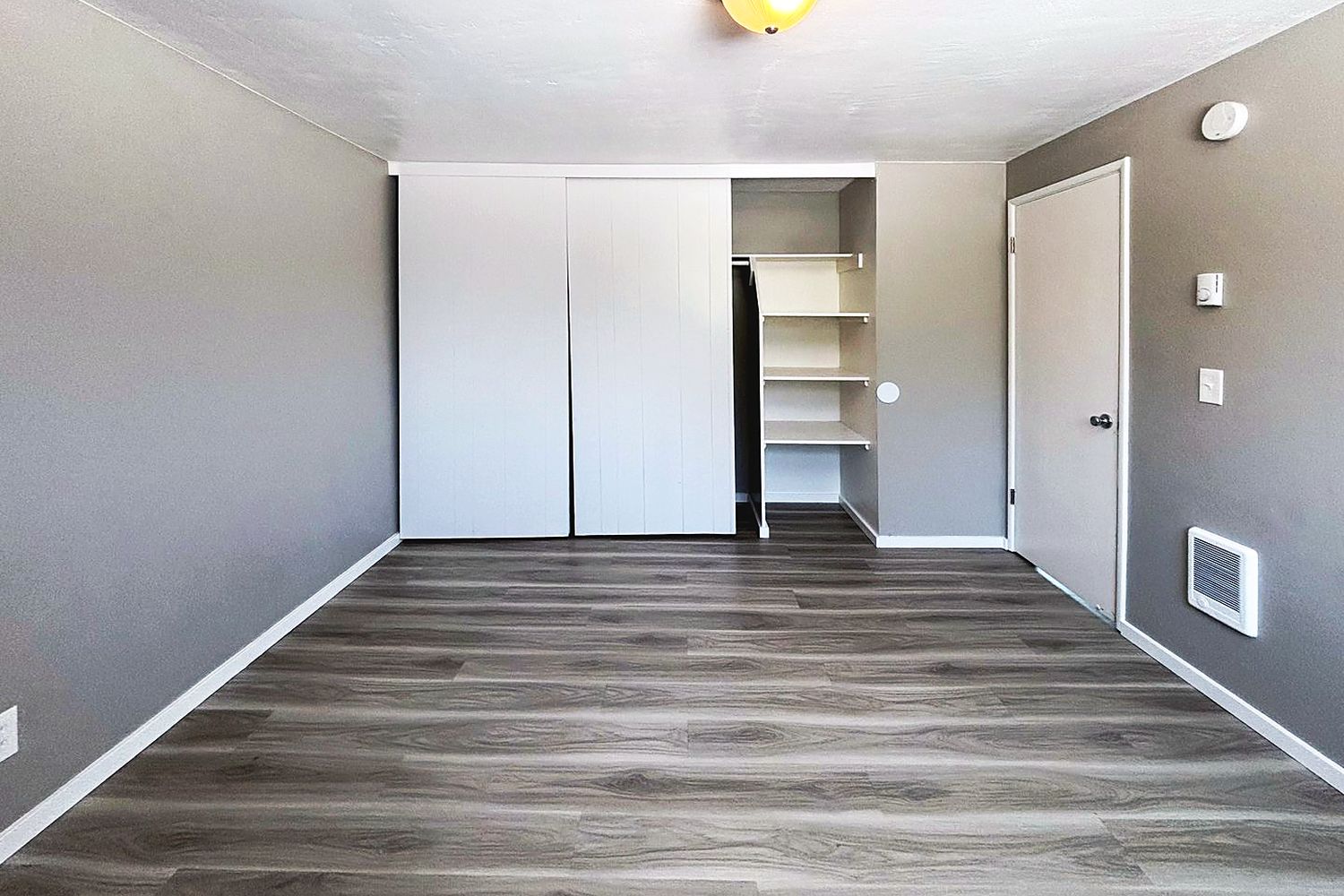 Bedroom with a wall of closet